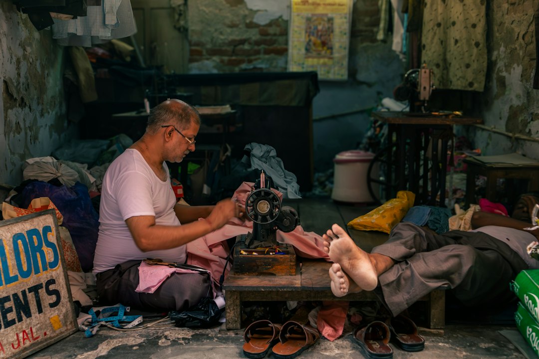 A tailor working at a small business in India, a typical PM Mudra Yojana borrower